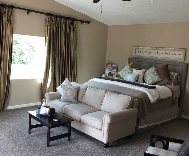 sexy neutral master bedroom with draperies