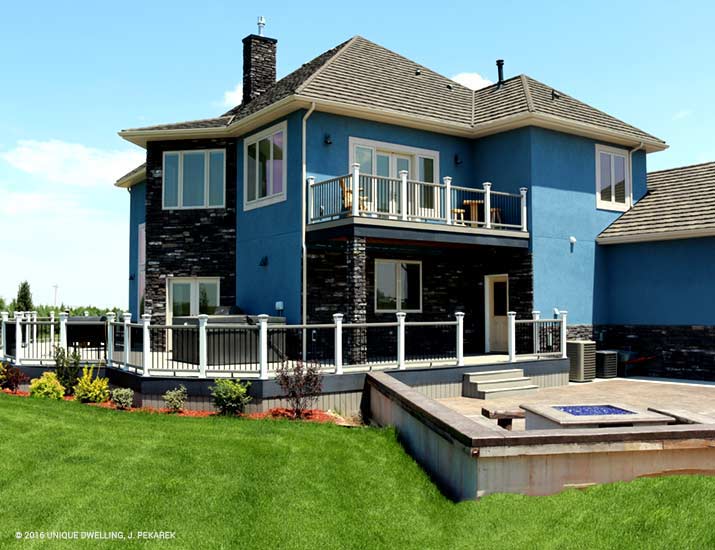 contemporary house with blue stucco charcoal grey brick and porch and patio