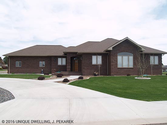 ranch house dark brick brown roof and windows