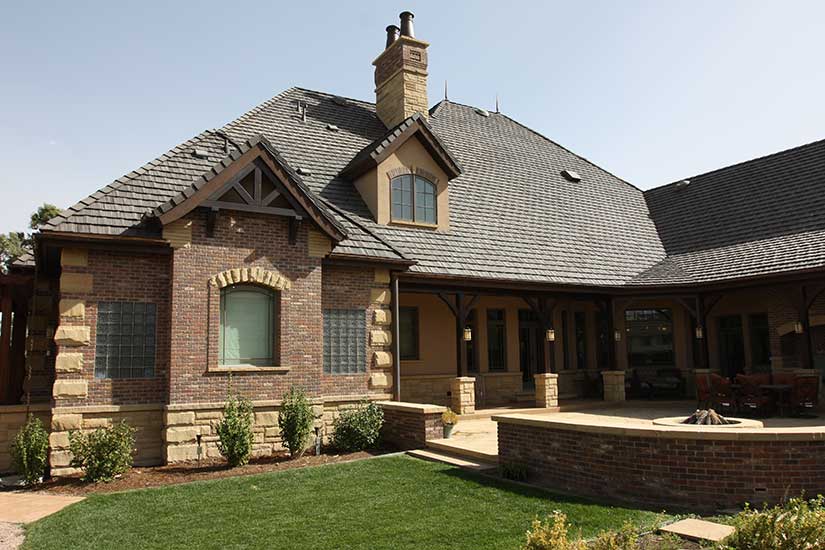 patio with brick border, covered walk way, stone accent