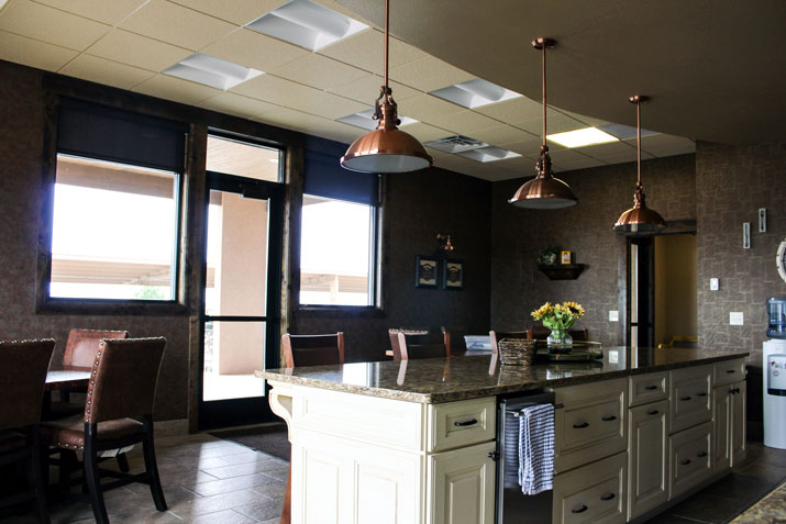 white raised panel kitchen island with copper accent