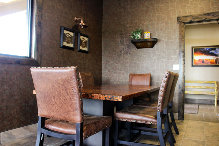 break area features wall paper knotty alder trim and a copper table and chairs