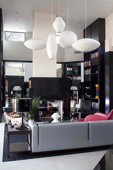 modern library with vaulted ceiling white walls black bookcase