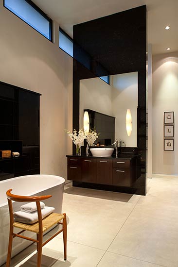 dramatic master bathroom with clearstory windows and fireplace