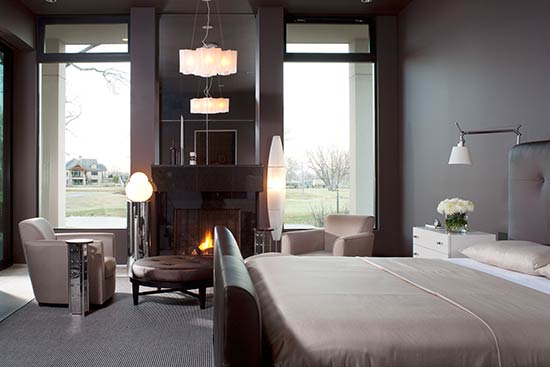 master bedroom with large windows deep wall color and neutral bedding