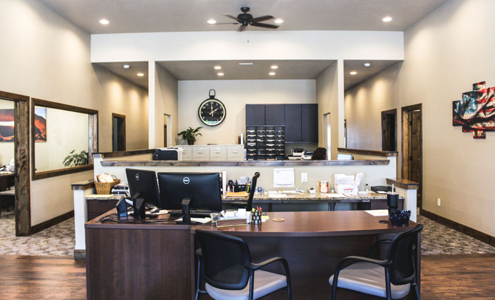 front office with vaulted ceiling reception desk and wood floor