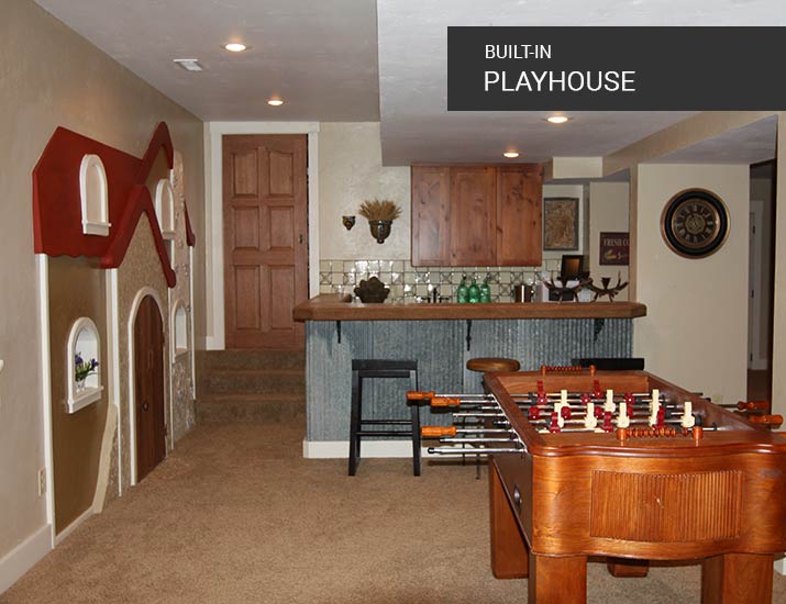 built-in playhouse in recreation room