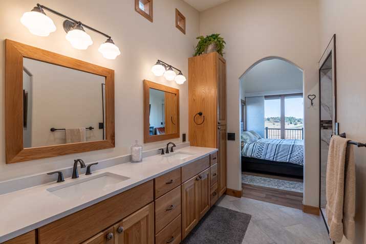 master bathroom with double vanity, linen storage and open concept
