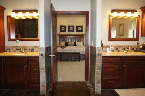 dual cherry cabinet vanities in master bathroom