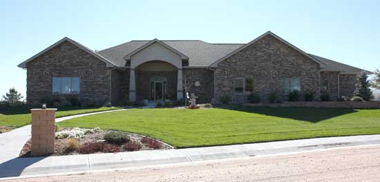 house with brick and stucco and grand front entrance