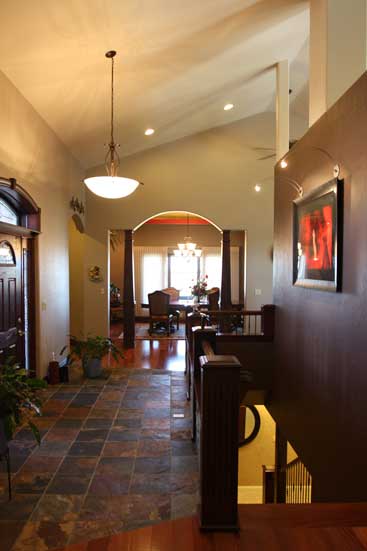 entrance with vaulted ceiling, slate floor and staircase