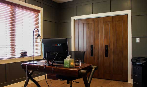 dark forest green private office with wood accents